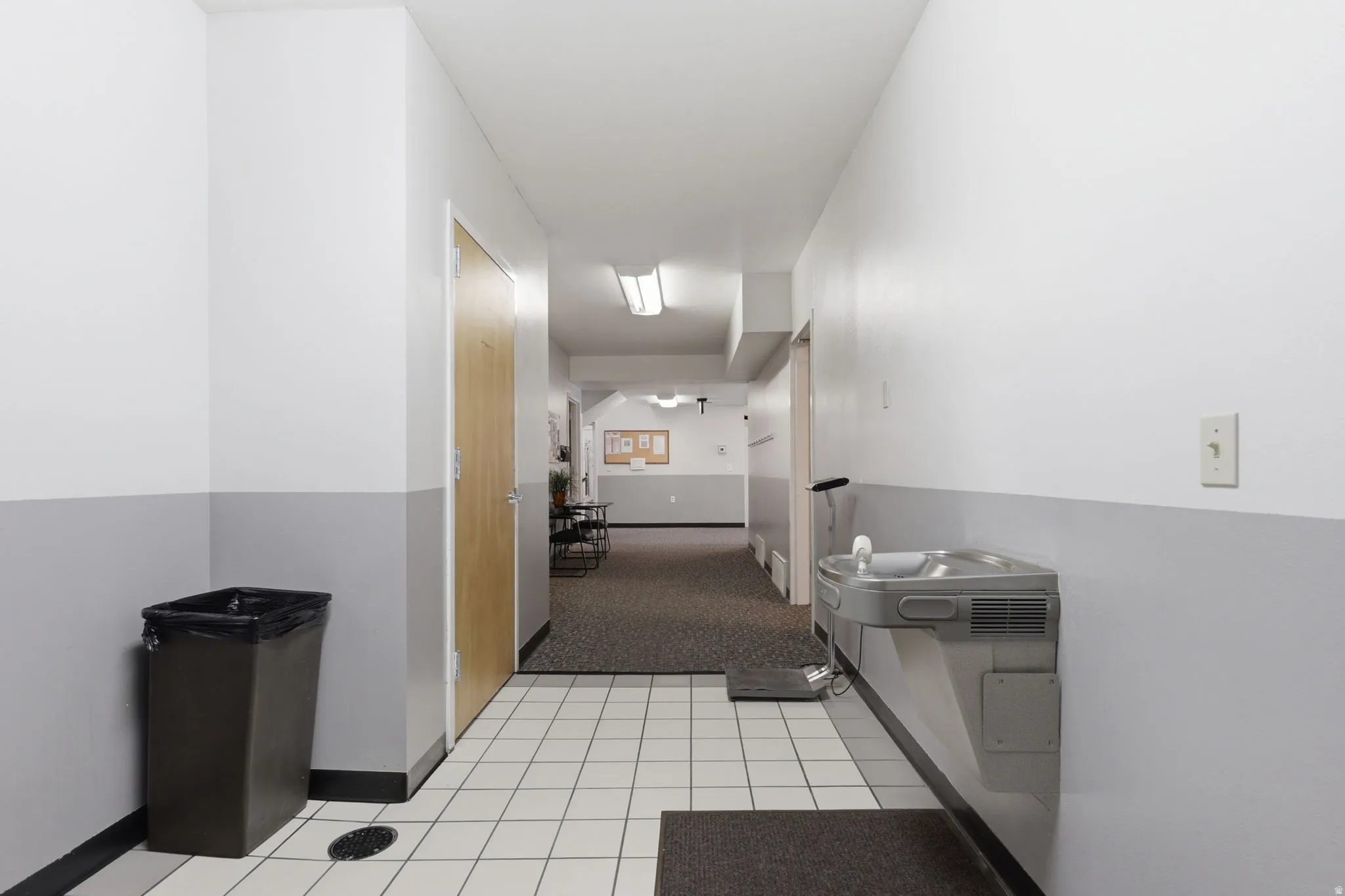 Efficient break room featuring stainless steel appliances, ceramic tile flooring, and ample counter space