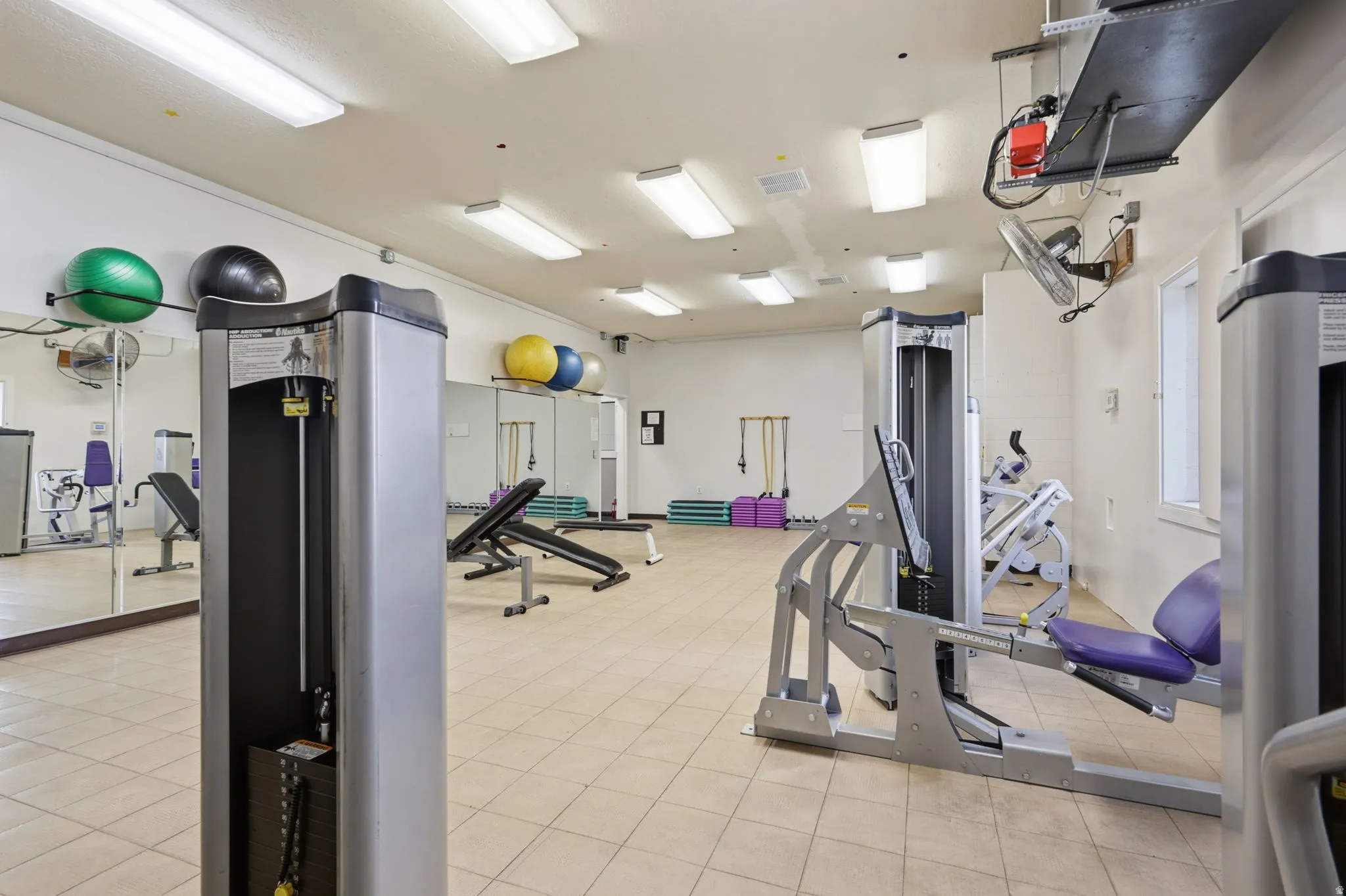 State-of-the-art fitness facility featuring comprehensive exercise equipment, including cardio machines, strength training apparatus, and functional training tools