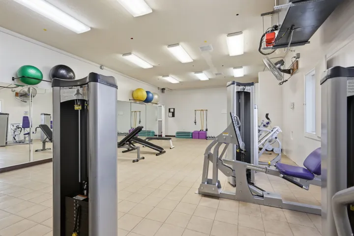 State-of-the-art fitness facility featuring comprehensive exercise equipment, including cardio machines, strength training apparatus, and functional training tools