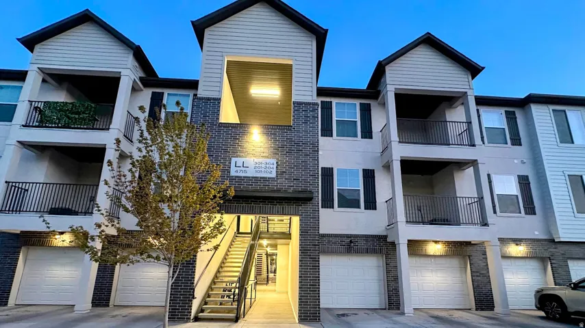 Multi-level building exterior featuring brick and siding accents