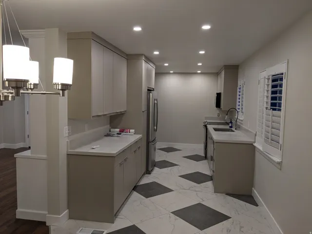 Kitchen featuring recessed lighting, contemporary cabinetry, light-toned countertops, stainless steel appliances, and checkerboard floor tiling