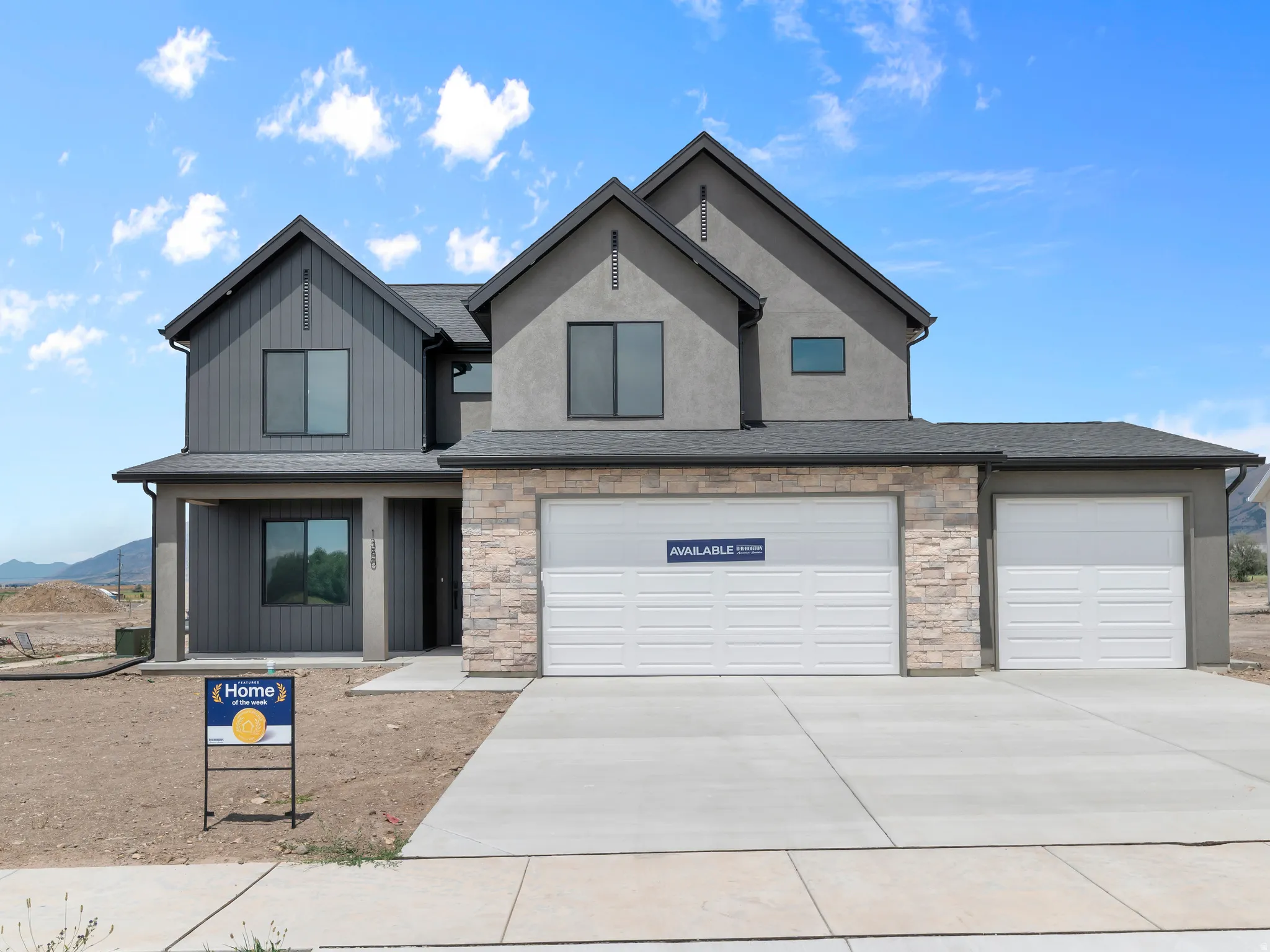 Contemporary exterior featuring a combination of horizontal siding, stucco, and stone veneer