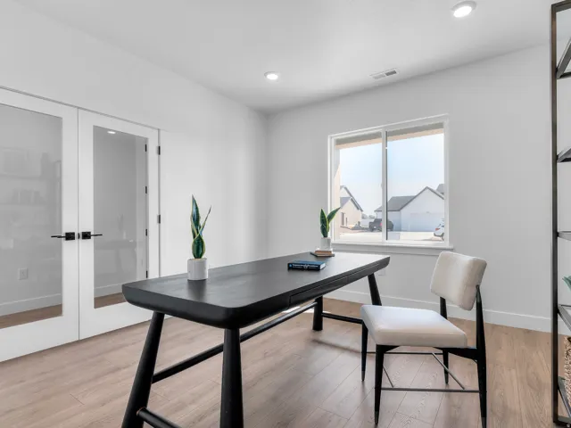 Recessed lighting, wood-finish flooring, and a large window