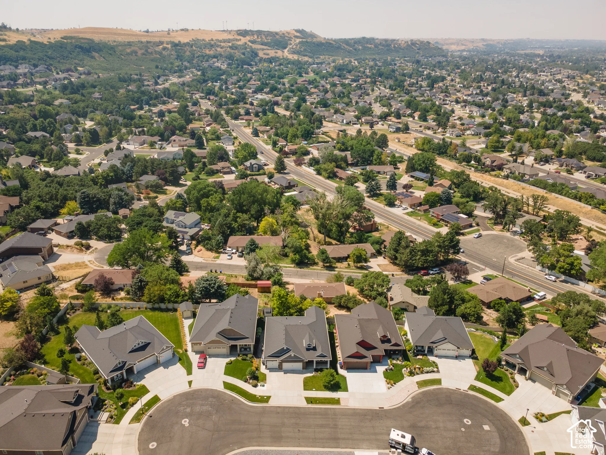 Expansive residential neighborhood with varied architectural styles, mature trees, and paved streets