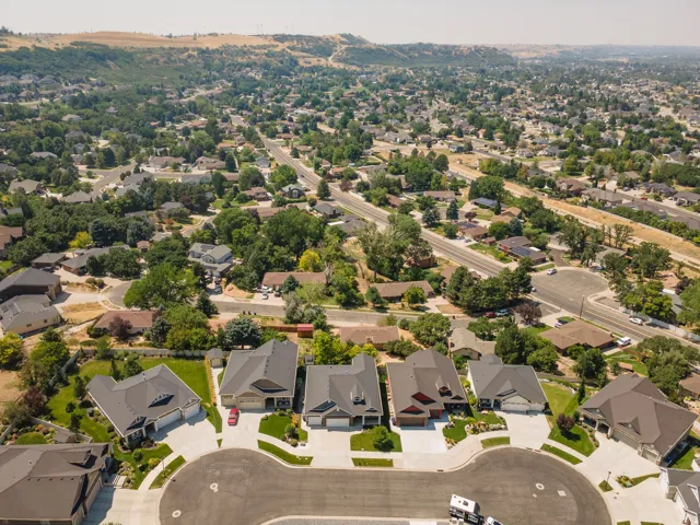 Expansive residential neighborhood with varied architectural styles, mature trees, and paved streets