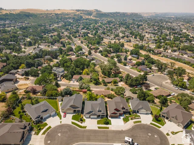 Expansive residential neighborhood with varied architectural styles, mature trees, and paved streets