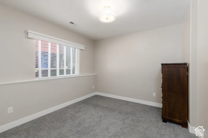 Recessed window with blinds, overhead flush-mount light fixture, and neutral wall tones