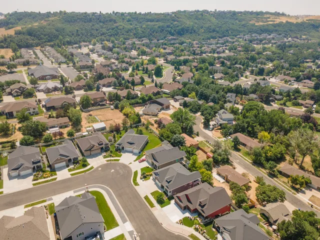 Aerial perspective of a residential neighborhood with varied architectural styles and mature trees