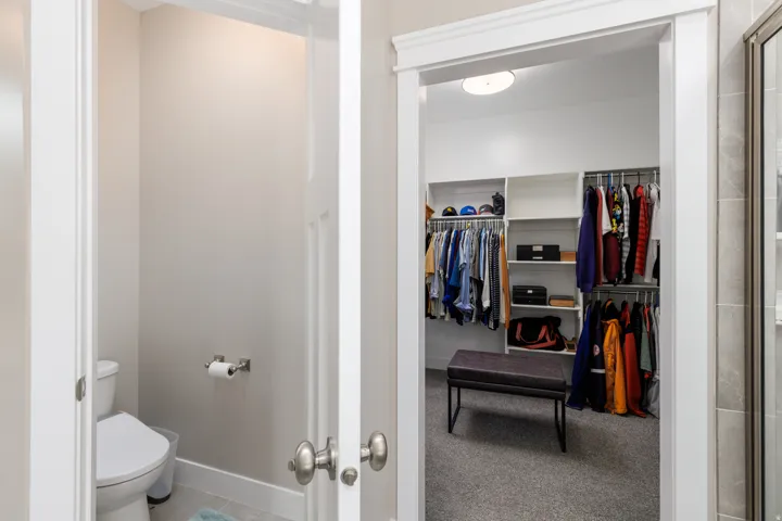 Walk-in closet with built-in shelving and clothing rods
