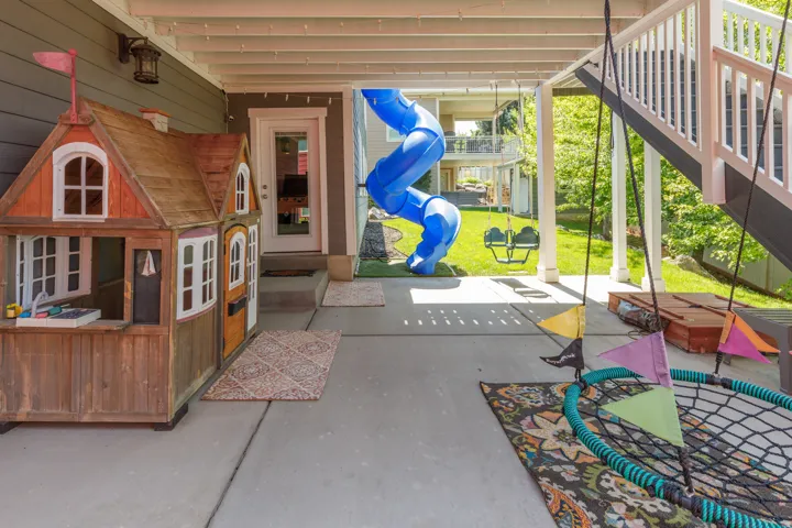 Patio with concrete flooring, support columns, and access to a grassed outdoor area