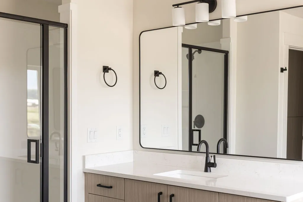 Vanity with integrated sink, stone-finish countertop, and wood-finish cabinetry