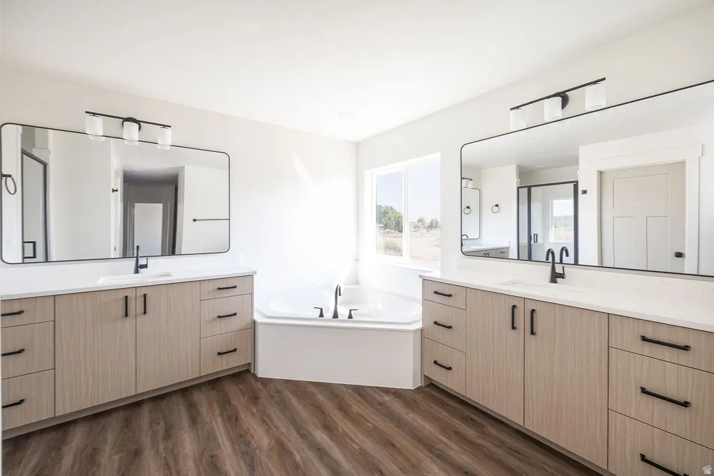 Dual vanities with white countertops, wood-finish cabinetry, and matte black fixtures
