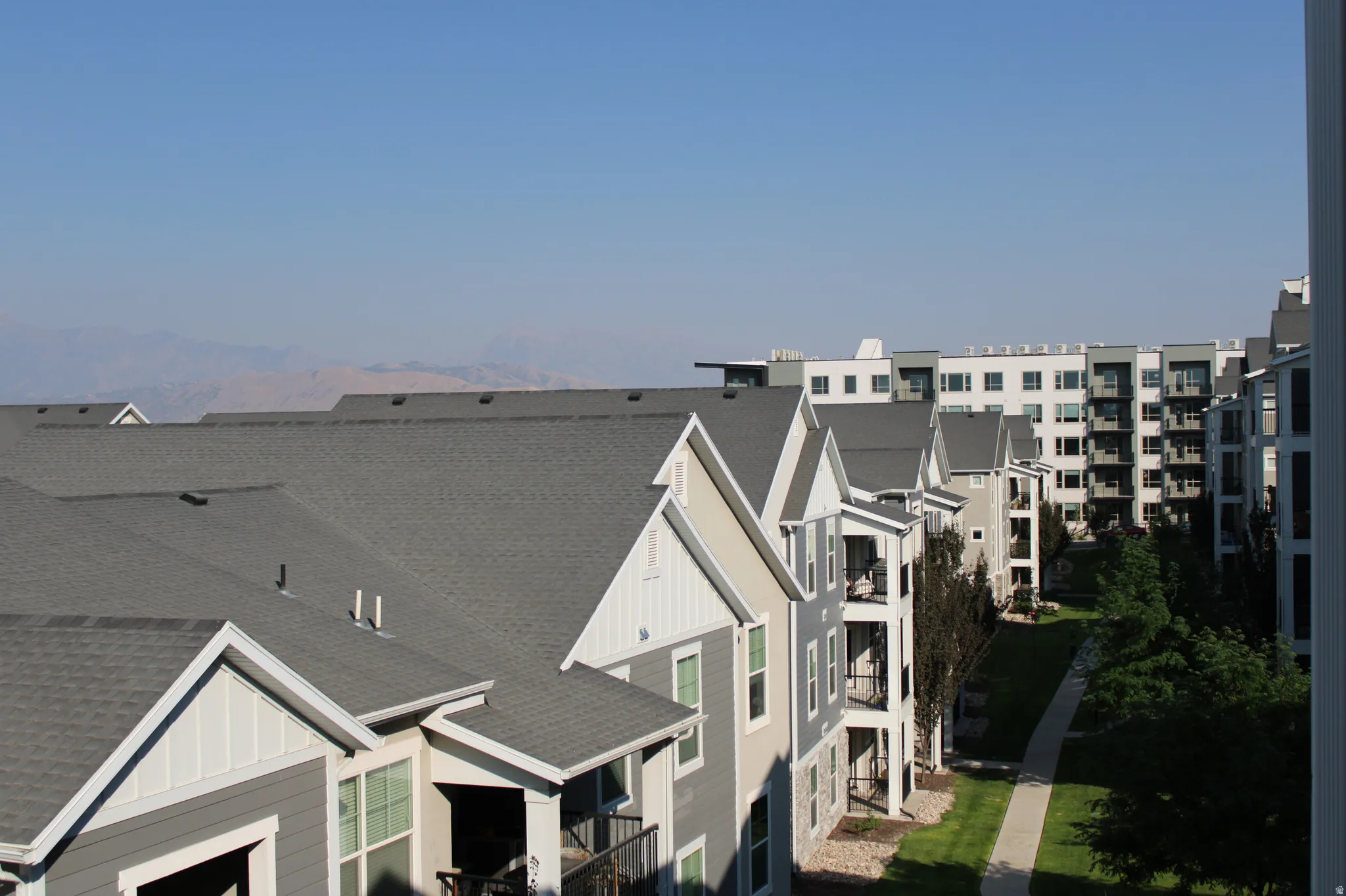 Multi-story residential buildings featuring gabled roofs and private balconies