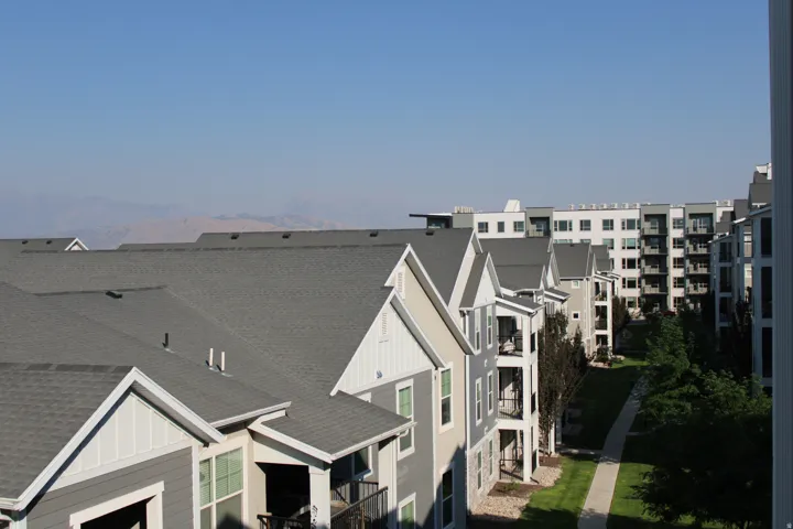 Multi-story residential buildings featuring gabled roofs and private balconies