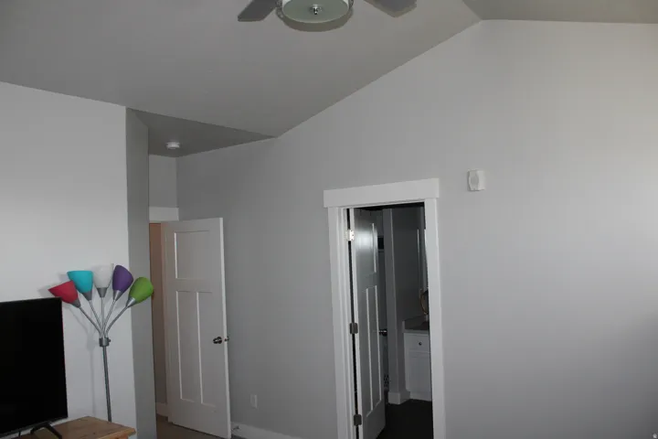 Vaulted ceiling, white trim, recessed lighting, ceiling fan, contemporary interior doors