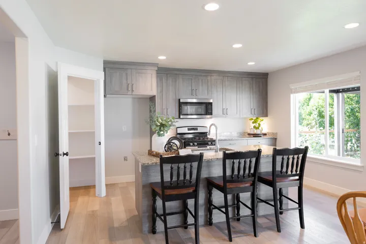 Kitchen featuring light wood-finish flooring, recessed lighting, and a pantry with built-in shelving