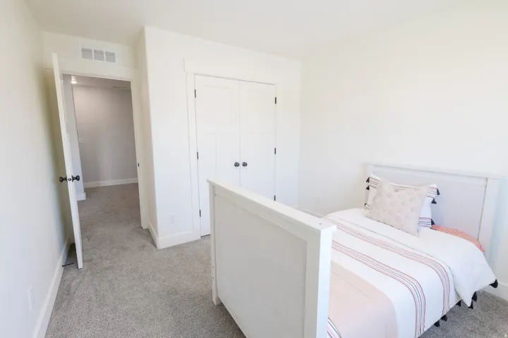 Wall-to-wall carpeting and white walls
