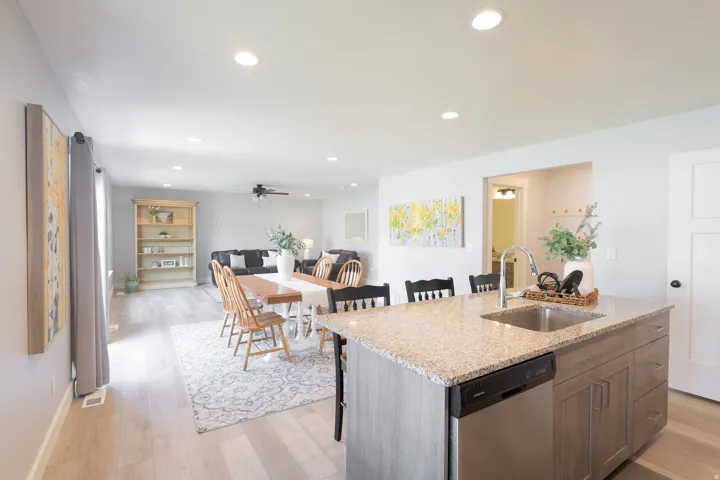 Kitchen island with a granite countertop and an undermount sink