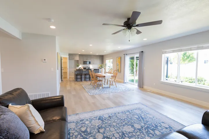 Open-concept living space featuring wood-finish flooring, recessed lighting, and a ceiling fan