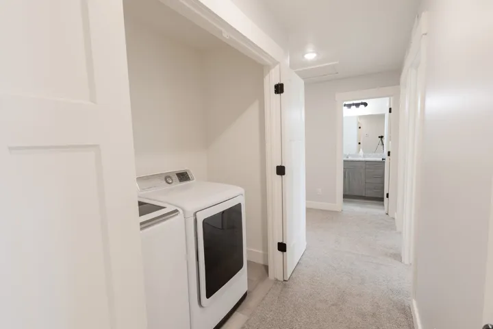 Laundry area with wood-finish flooring