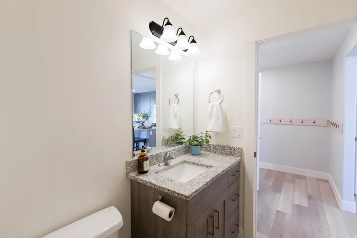 Vanity with a granite-style countertop and an undermount sink