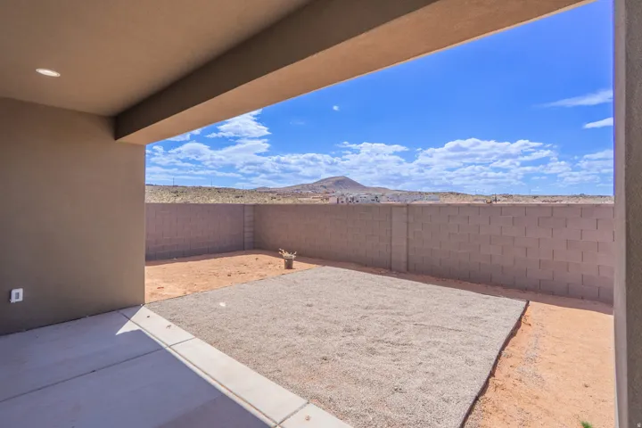 Covered patio with recessed lighting, concrete flooring, and a low-maintenance yard