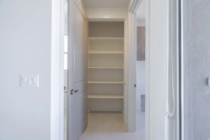 Built-in shelving unit with multiple storage surfaces and a clean white finish
