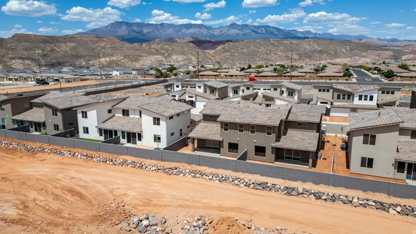 Contemporary residential development featuring multi-story homes with stucco exteriors