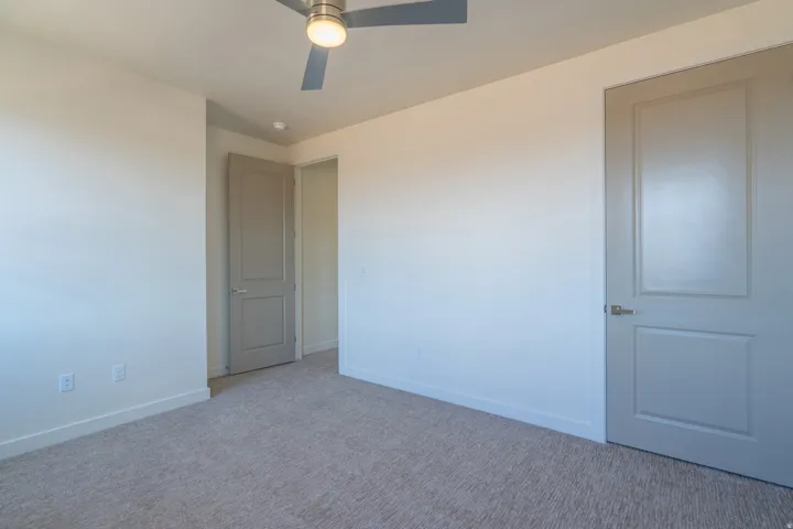 Neutral-toned carpet flooring complementing light-colored walls