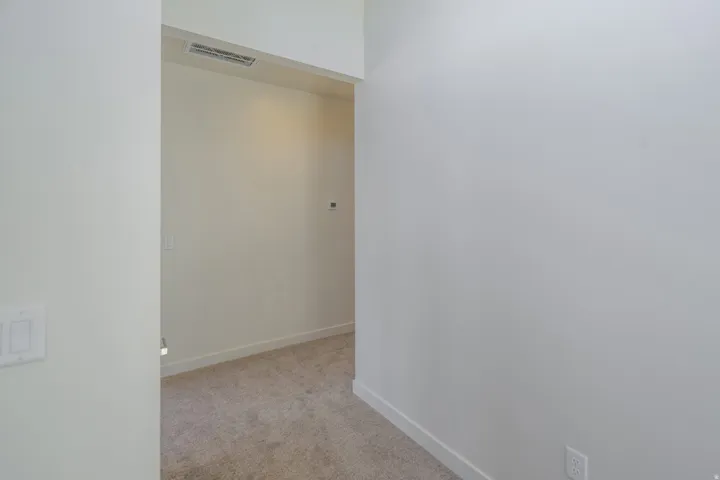 Entryway featuring light-toned walls, white trim, and neutral carpeting