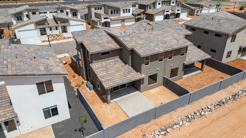 Modern stucco exterior with multi-toned shingle roofing