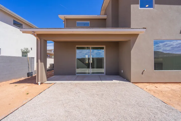 Covered patio featuring a concrete slab and sliding glass doors