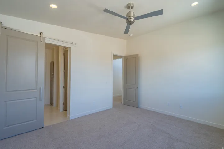 Neutral tone carpeted flooring complements light-toned walls