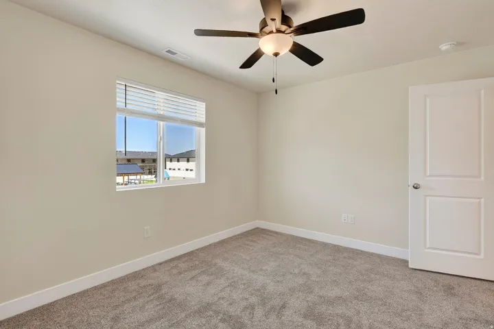 Neutral toned walls, contemporary ceiling fan with integrated lighting, window with blinds, and paneled door