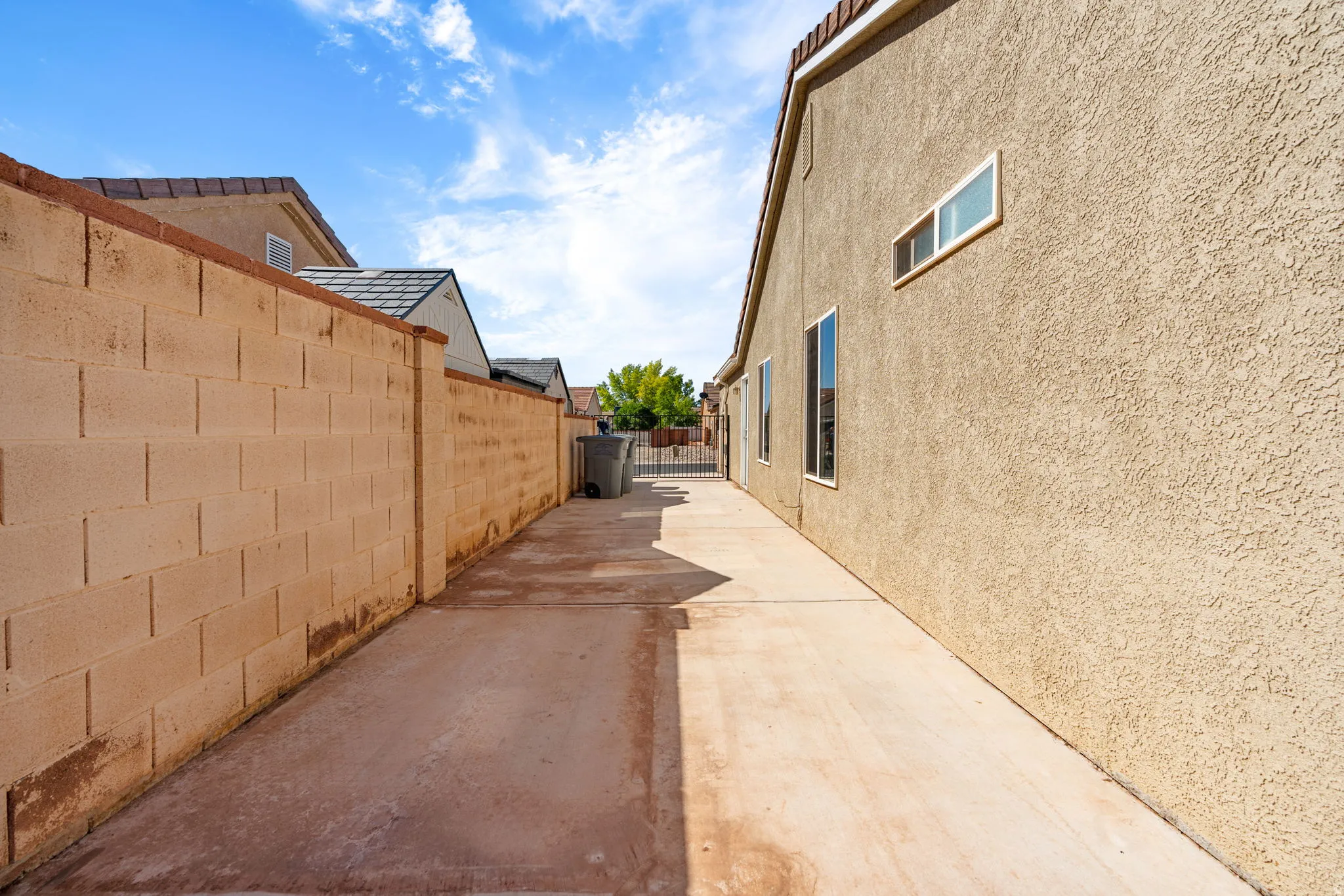 Concrete walkway alongside a stucco exterior
