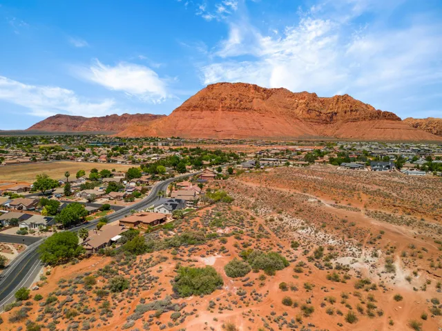 Expansive residential area with a prominent mountain backdrop, surrounded by arid vegetation