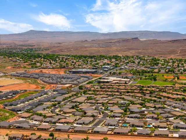 Expansive residential area featuring a mix of housing styles, established landscaping, and undeveloped land