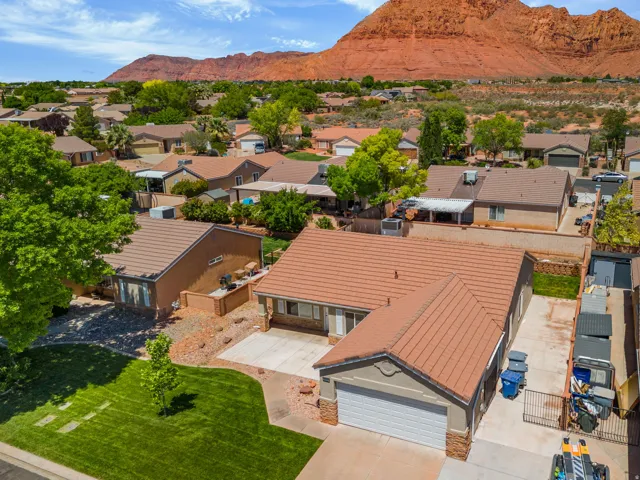 Single-story residence with a two-car garage, concrete tile roofing, and stone facade accents