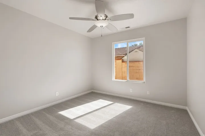 Recessed lighting, ceiling fan, carpet flooring, window with white trim, light gray painted walls