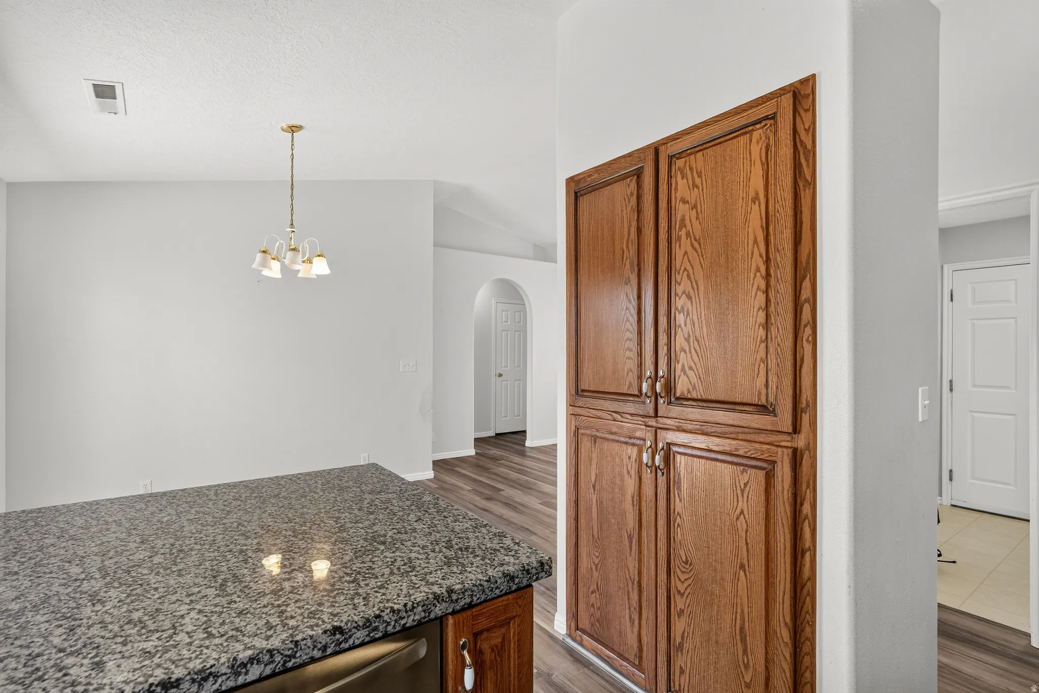 Kitchen island with a speckled countertop and integrated stainless-steel appliance
