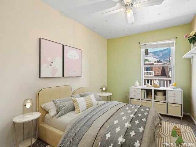 Window with mountain backdrop, ceiling fan, built-in shelving unit, wall-mounted shelving