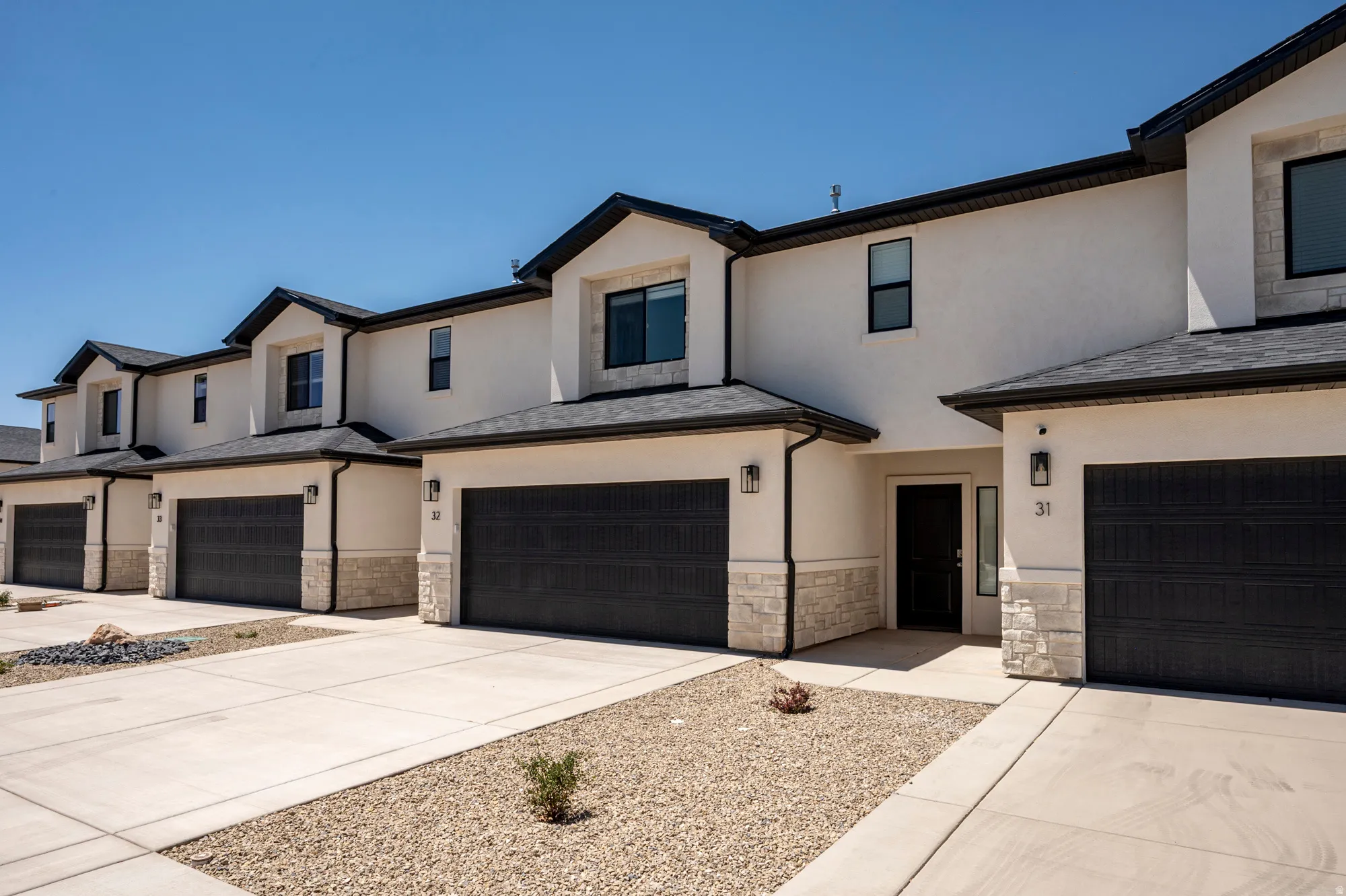 Modern facade with textured stucco and stone veneer accents
