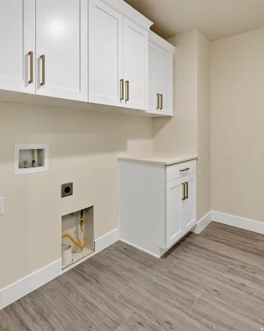 White shaker-style cabinetry with bronze hardware