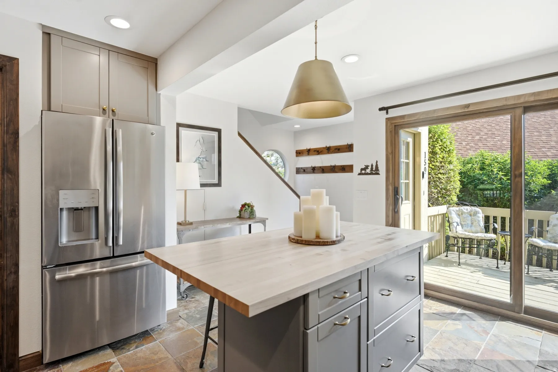 Stainless steel French door refrigerator with upper cabinetry