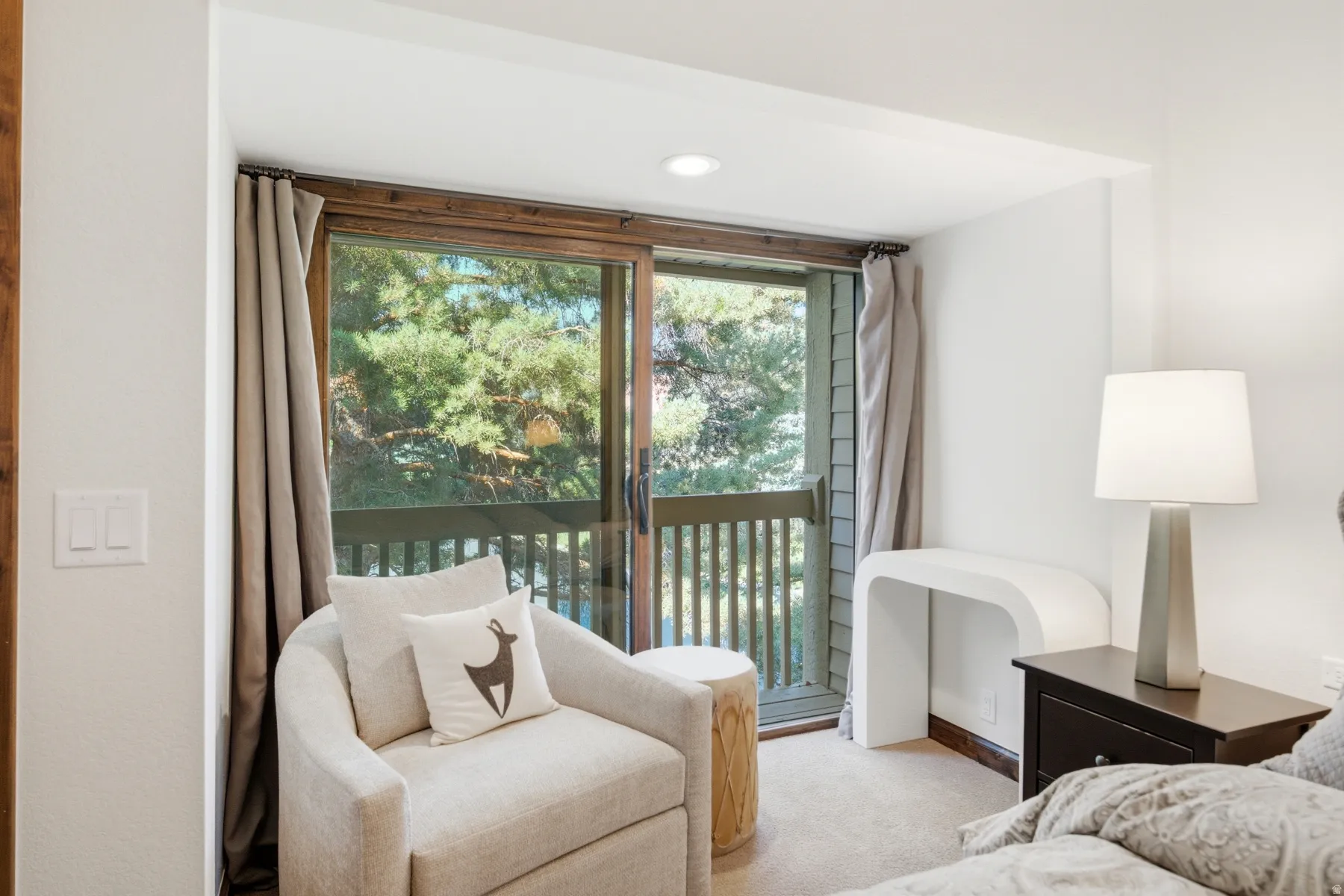 Sliding glass door leading to a balcony with wooden railings