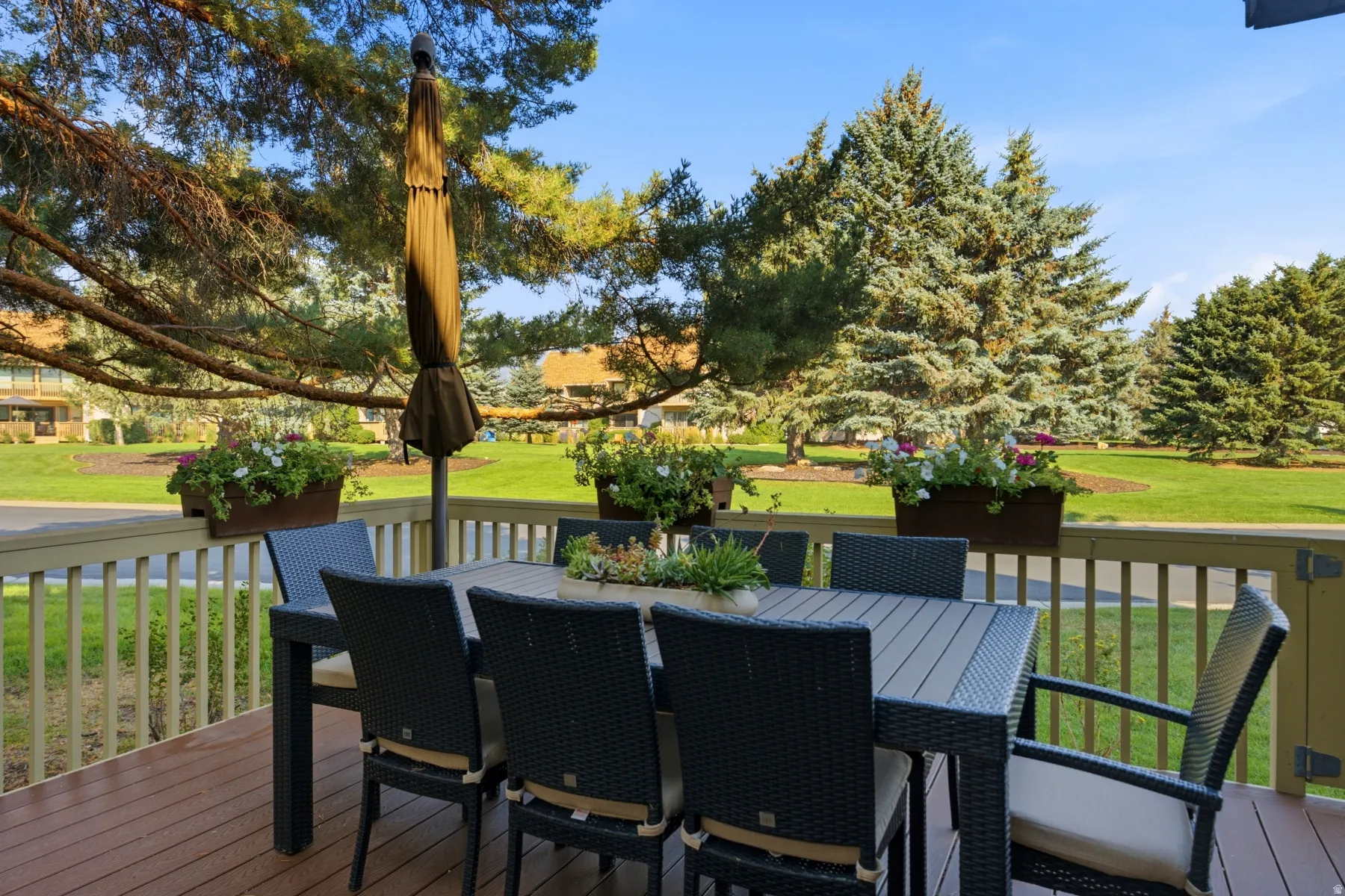 Expansive outdoor deck featuring wood-finish flooring and a wood railing