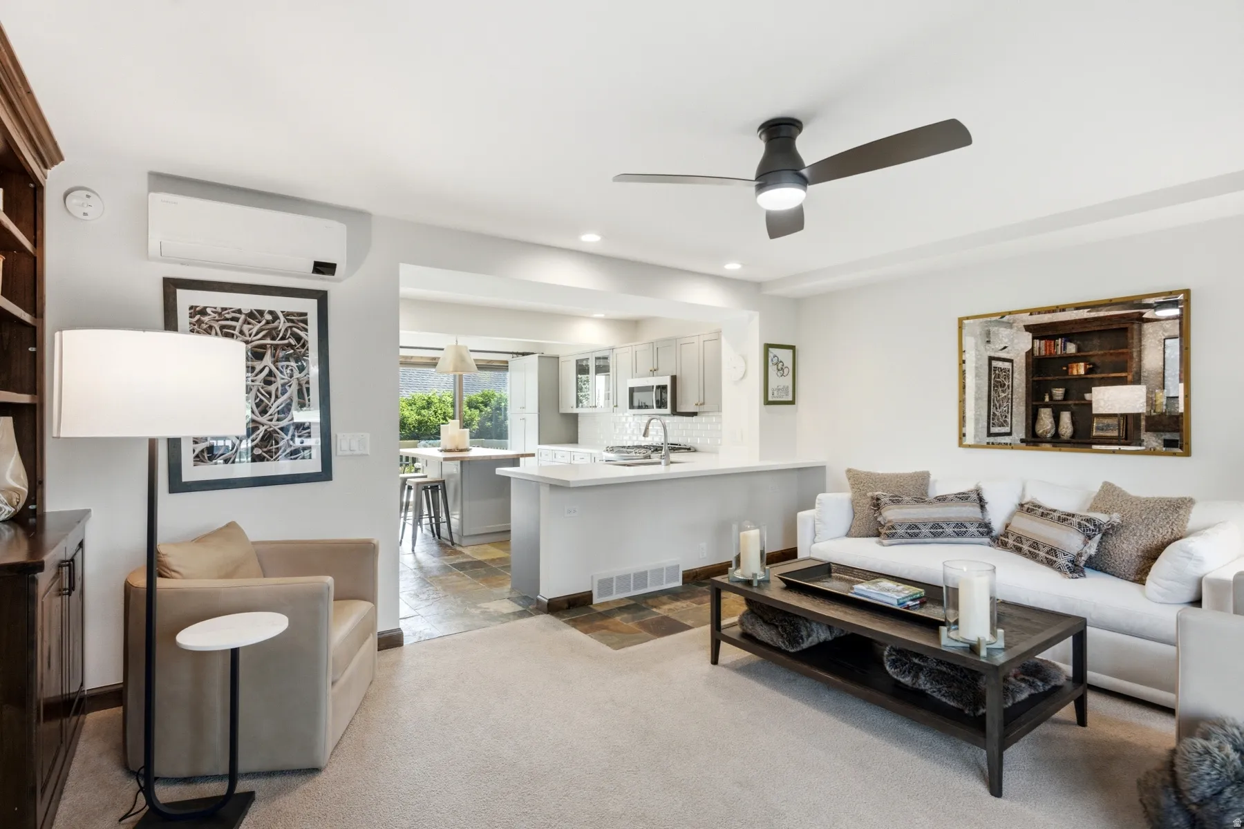 Living area featuring a ceiling fan, recessed lighting, and light-toned carpeting