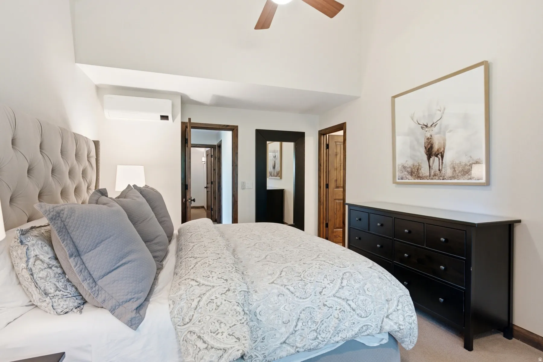 Vaulted ceiling with a wood-finish ceiling fan, recessed lighting, and split air conditioning unit