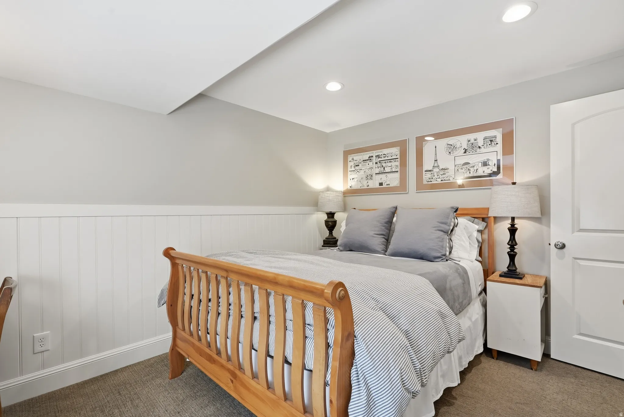 Recessed ceiling lighting, white beadboard wainscoting, and neutral wall tones