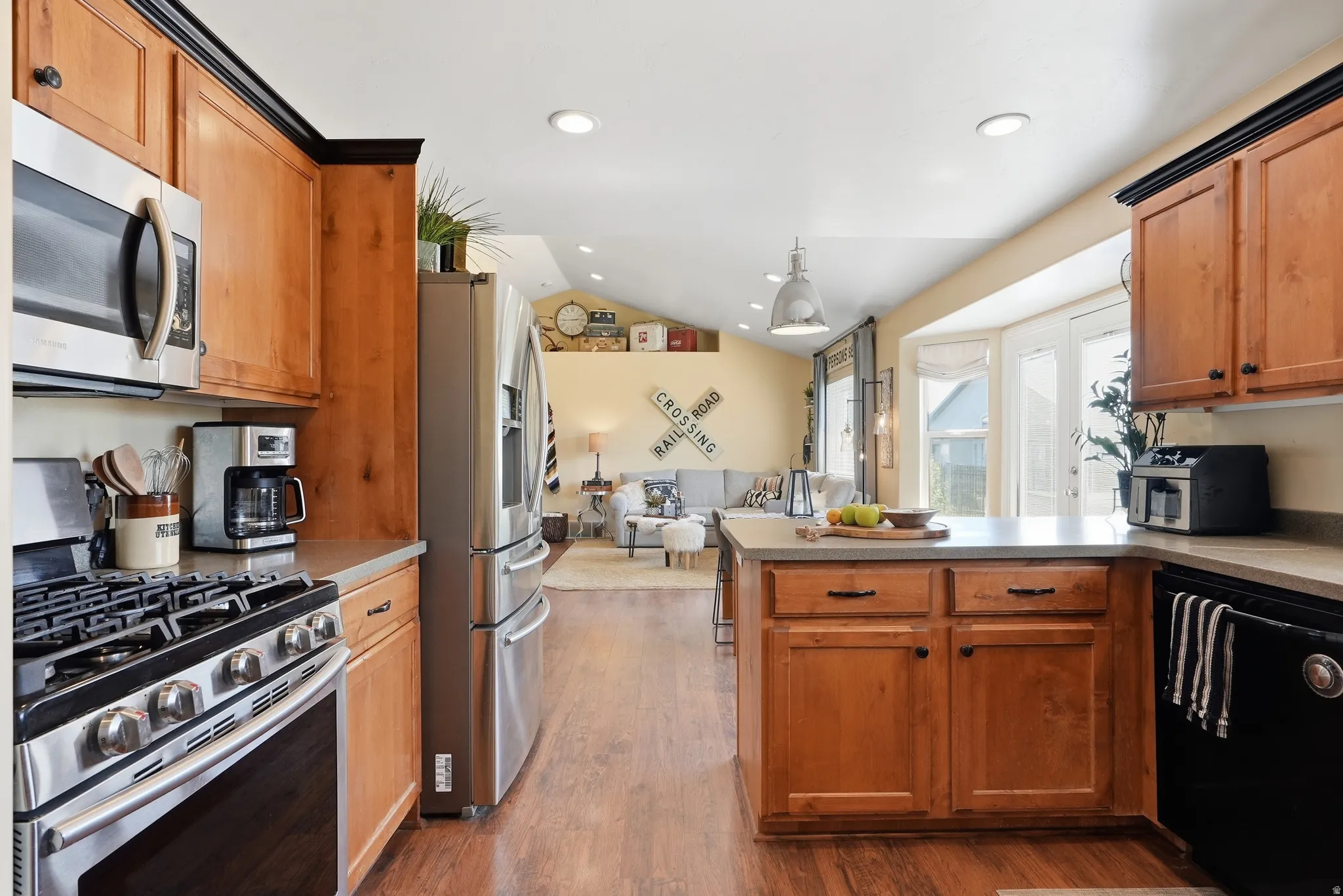 Kitchen featuring wood-finish flooring, stainless steel appliances, light-toned cabinetry, and recessed lighting
